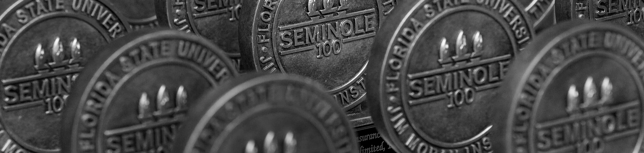 A row of silver Seminole 100 award medals