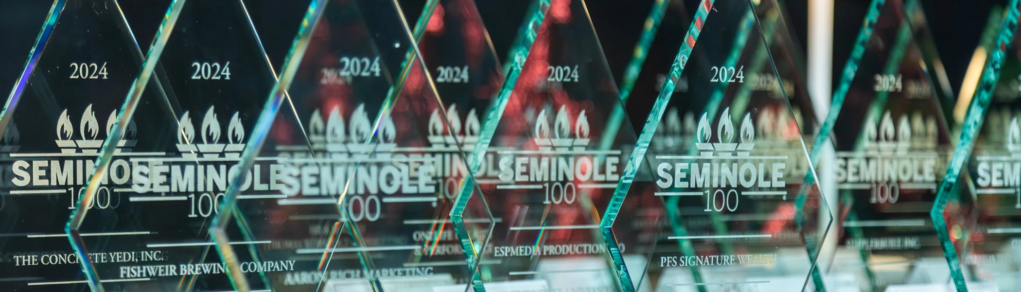 A row of glass Seminole 100 Awards