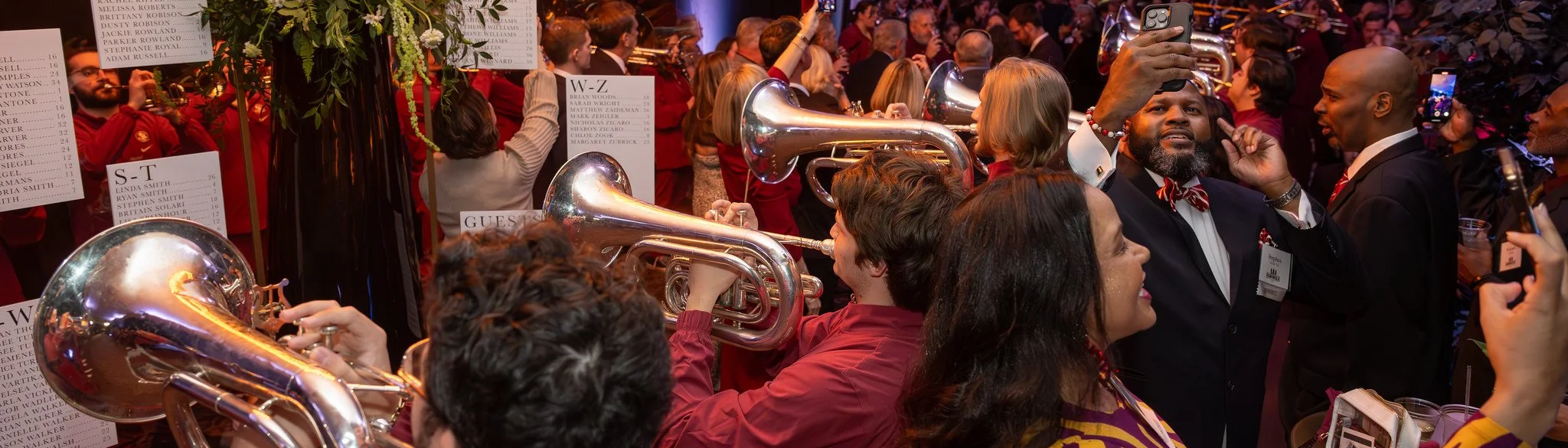 A photo of the Marching Chiefs performing in a crowd of Seminole 100 Awards attendees