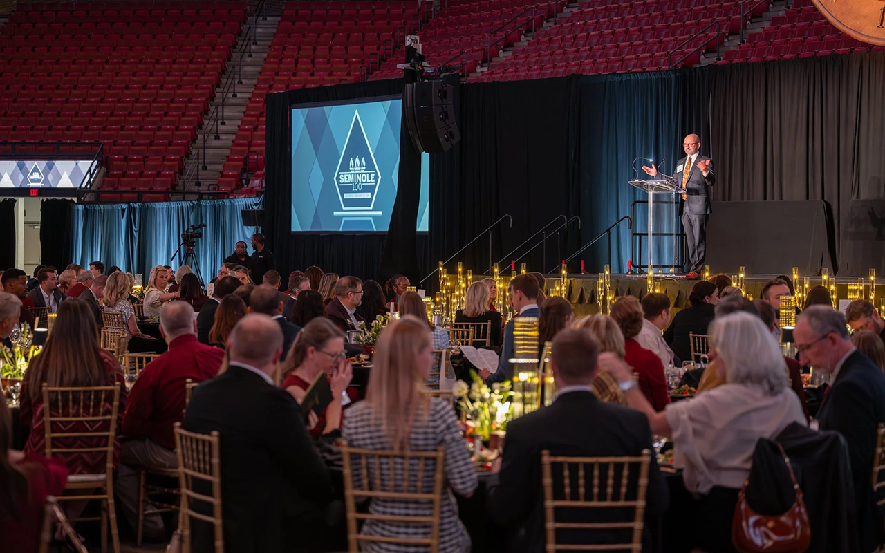 A speaker presenting at the Seminole 100 Awards ceremony